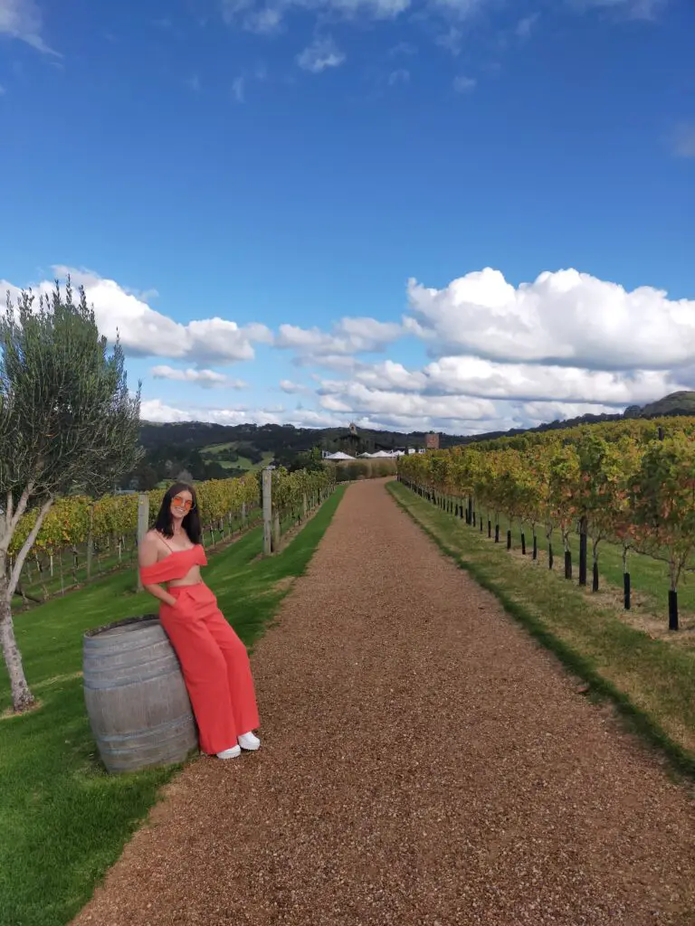 Things to do on Waiheke Island: Female standing among the vines at Tantalus Estate