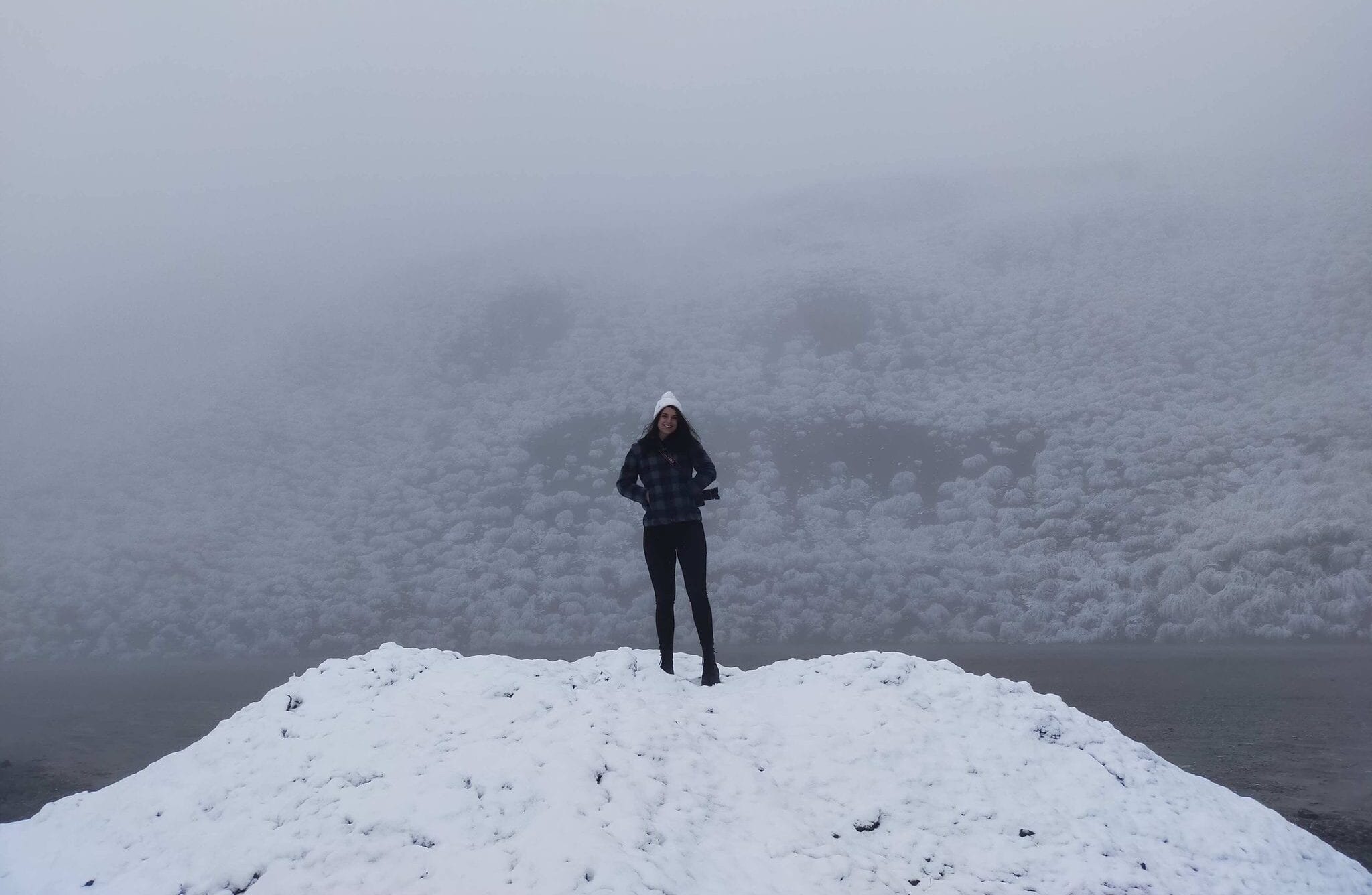 This photo shows a female standing on a mount of ice on The Remarkables Ski Field