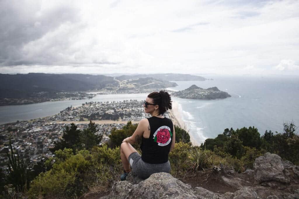 Female sitting at the summit of Mt Pauanui