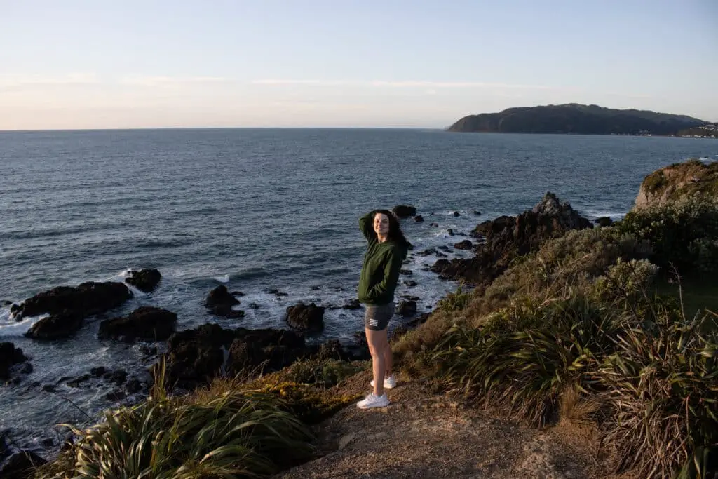 Standing on a cliff in Rocky Bay, watching a wellington sunset