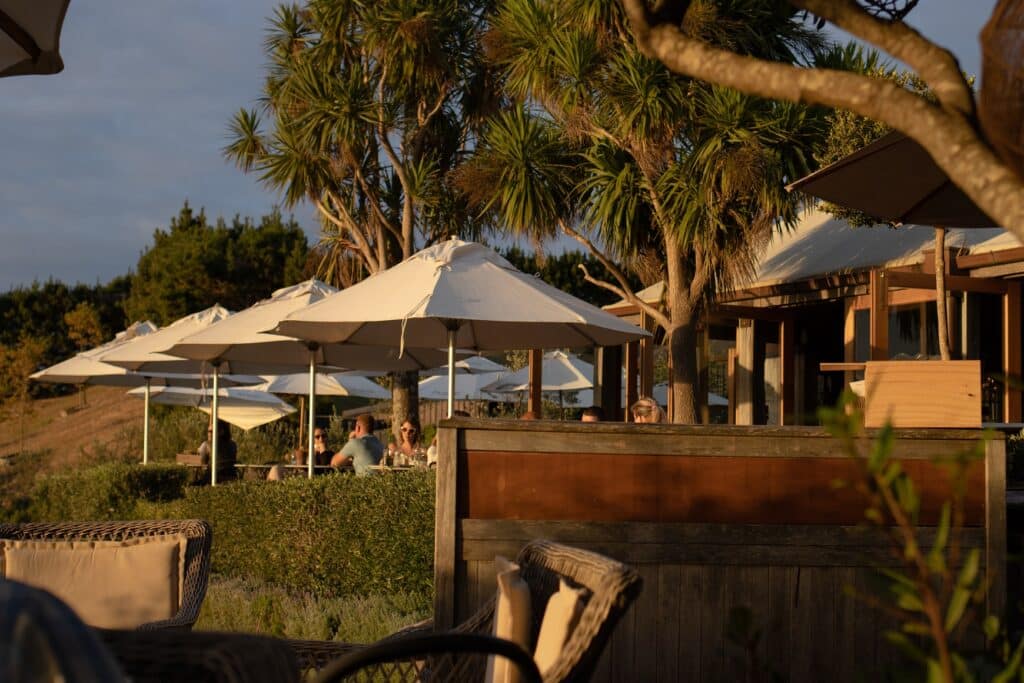 Things to do on Waiheke Island: View of the terraced deck at Mudbrick Vineyard during sunset