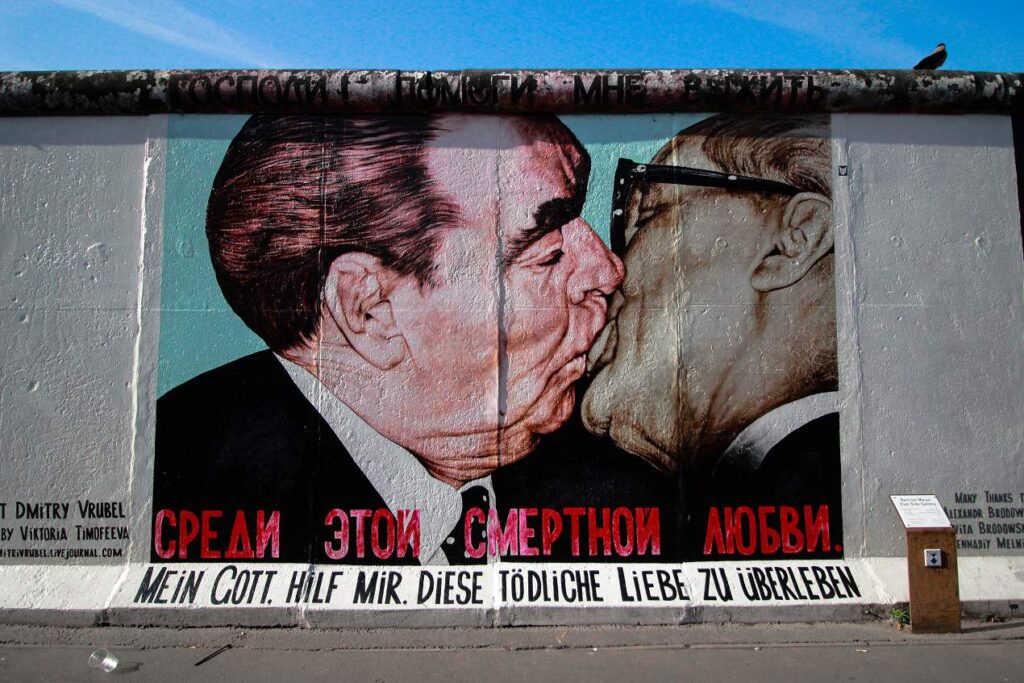 A painting on the Berlin Wall showing Leonid Brezhnev and East German leader Erich Honecker kissing. One of the best things to do in Berlin.