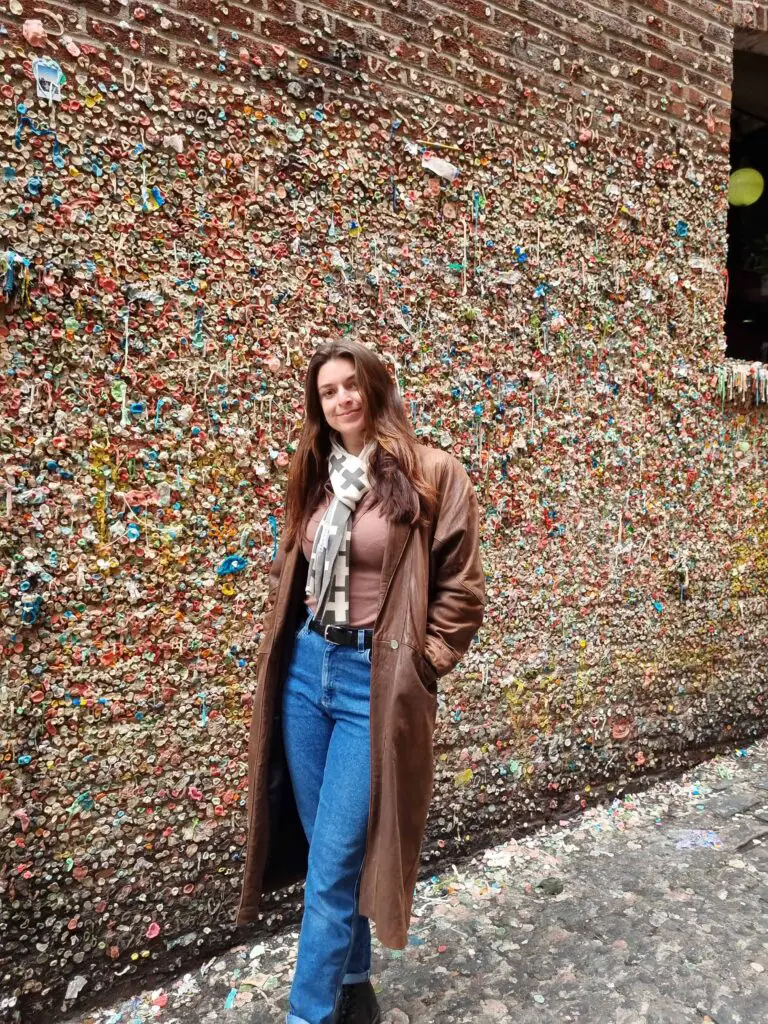 Female standing in front of the Seattle gum wall