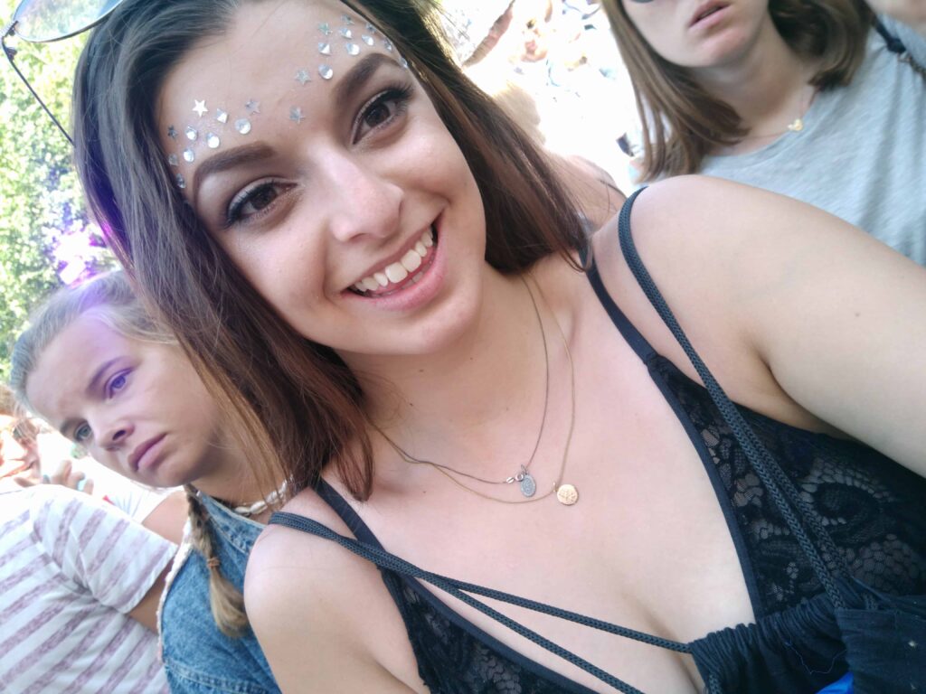 Tomorrowland Belgium: Survival Guide 2025 3 A female smiling at the camera, with gems stuck to her face