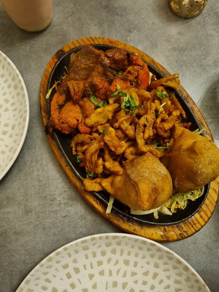 7 of The Best Indian Restaurants in Auckland 4 Mix platter of samosas, onion bhaji and chicken tikka. Served at Karam eatery, one of the best Indian restaurants in Auckland