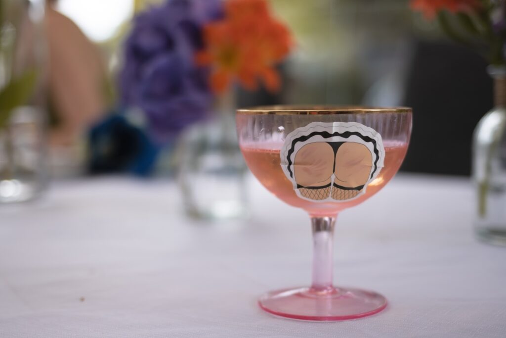 A champagne bowl with a sticker of a cartoon 'slapped bum'