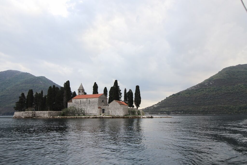 A photo showing one of the things to do in Kotor which is to visit Our Lady of the Rocks. This is a man-made island near Kotor.