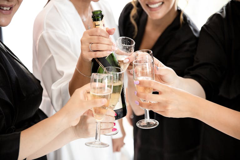 A group of women toasting with champagne glasses in a Hens party celebration