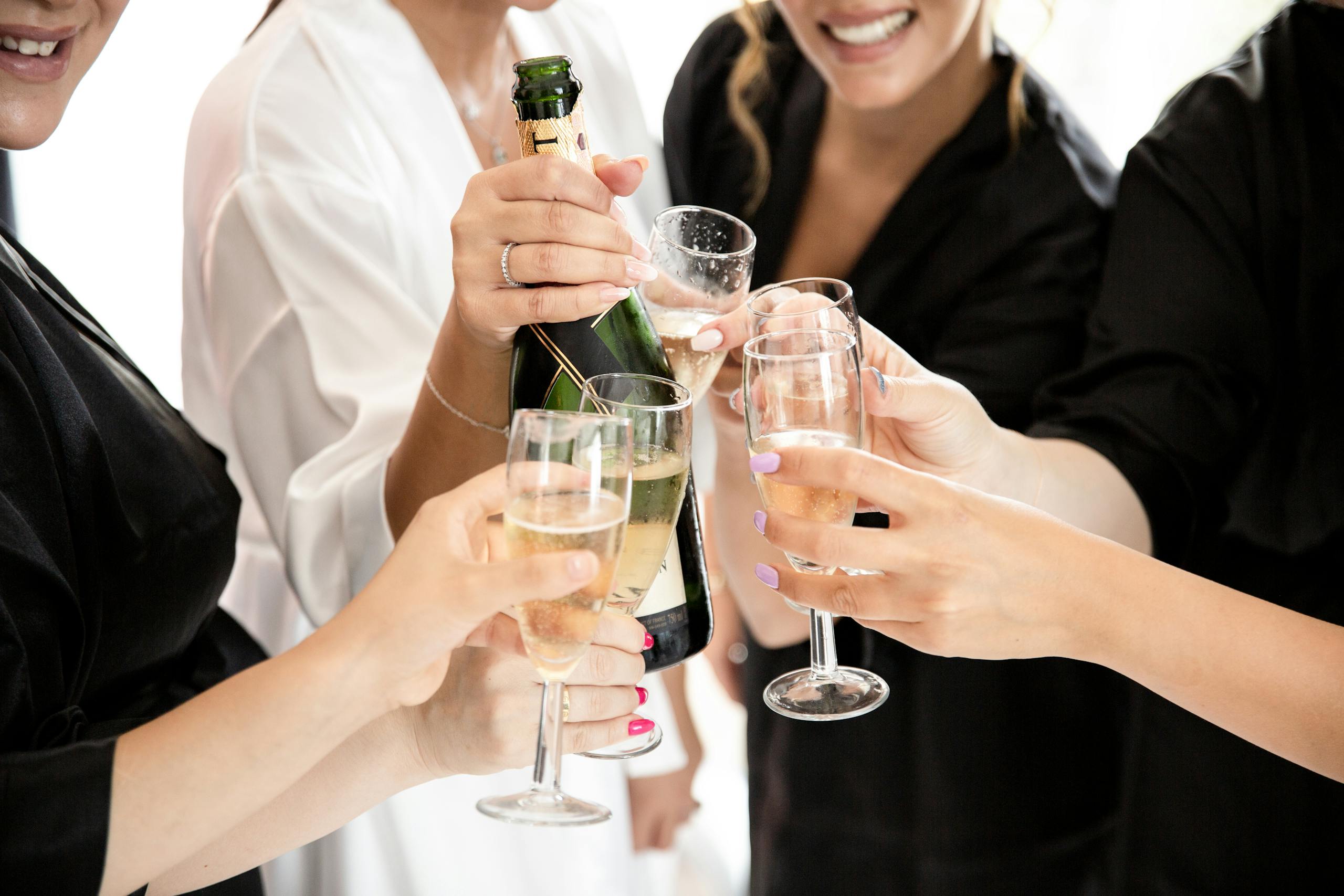 A group of women toasting with champagne glasses in a Hens party celebration