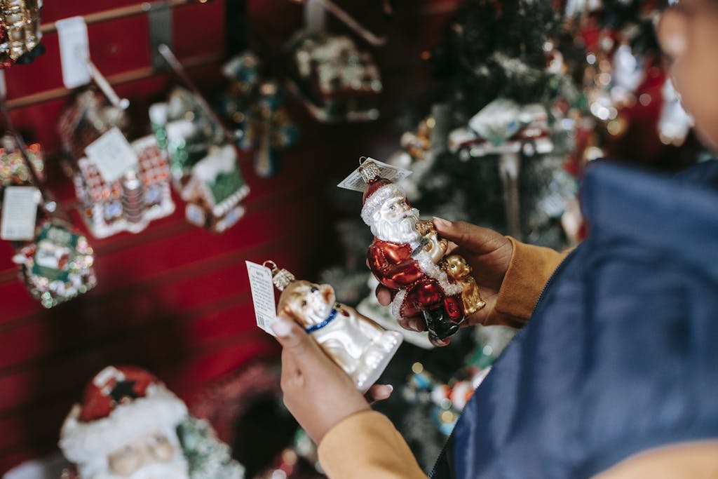 Side view of crop girl with Santa and dog toys standing in shop with Christmas decorations, in Auckland at Christmas events