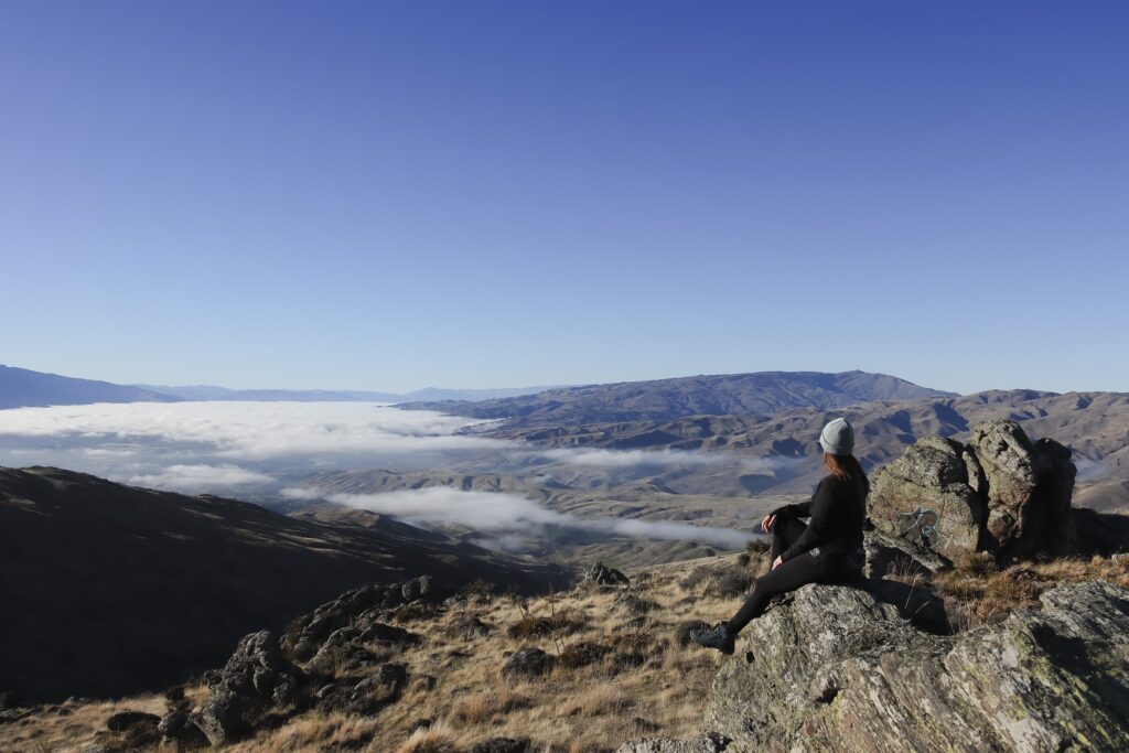 Amazing Queenstown Travel Guide 2026 Photo of a woman overlooking Bannockburn from the top of Nevis road lookout in Queenstown