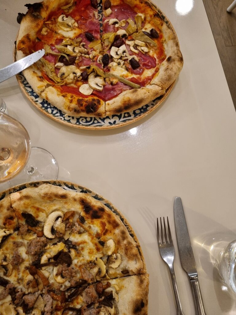 Best restaurants in Brisbane: This image shows two pizzas on a table at Cucina Regina restaurant in Brisbane.