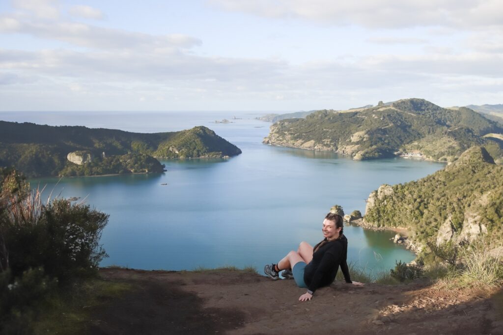 Female sitting on the edge of Dukes Nose lookout